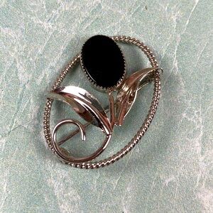 Vintage sterling silver floral brooch with an onyx oval stone